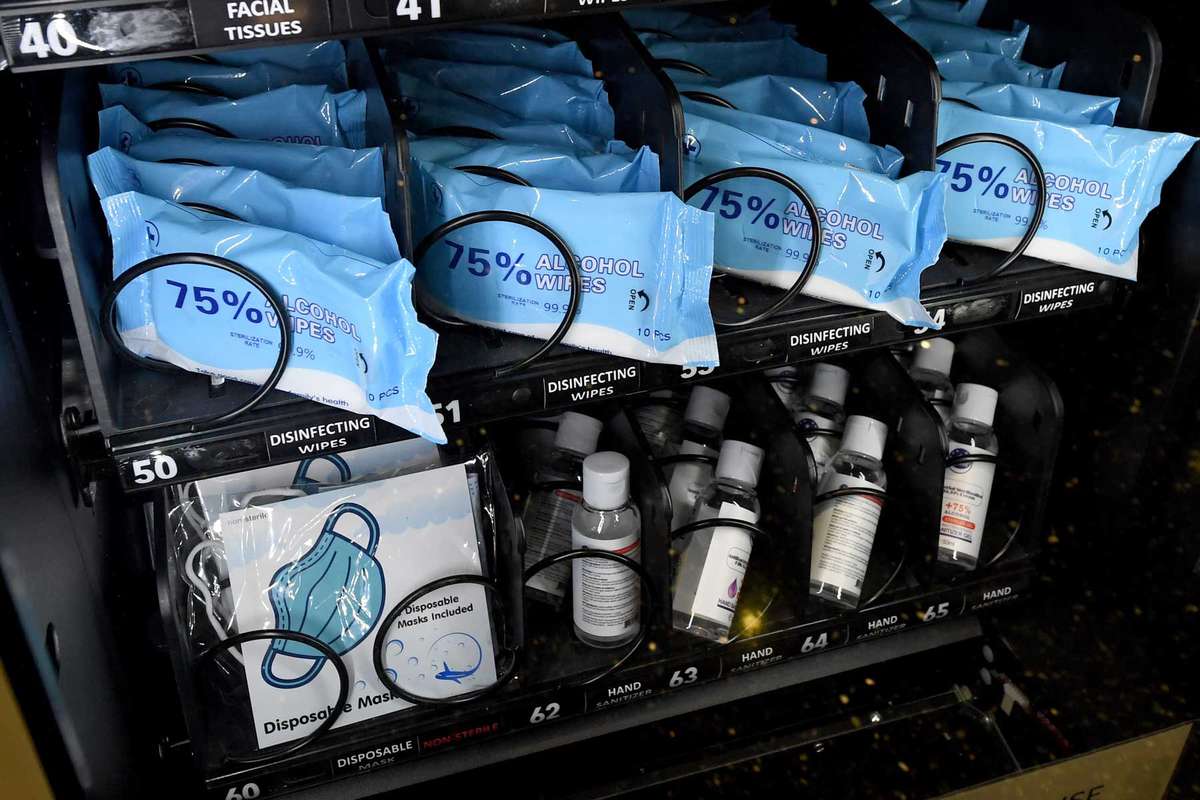 Alcohol disinfecting wipes, masks and bottles of hand sanitizer gel are displayed in a personal protective equipment vending machine in the Terminal 1 ticketing area at McCarran International Airport on May 14, 2020 in Las Vegas, Nevada.