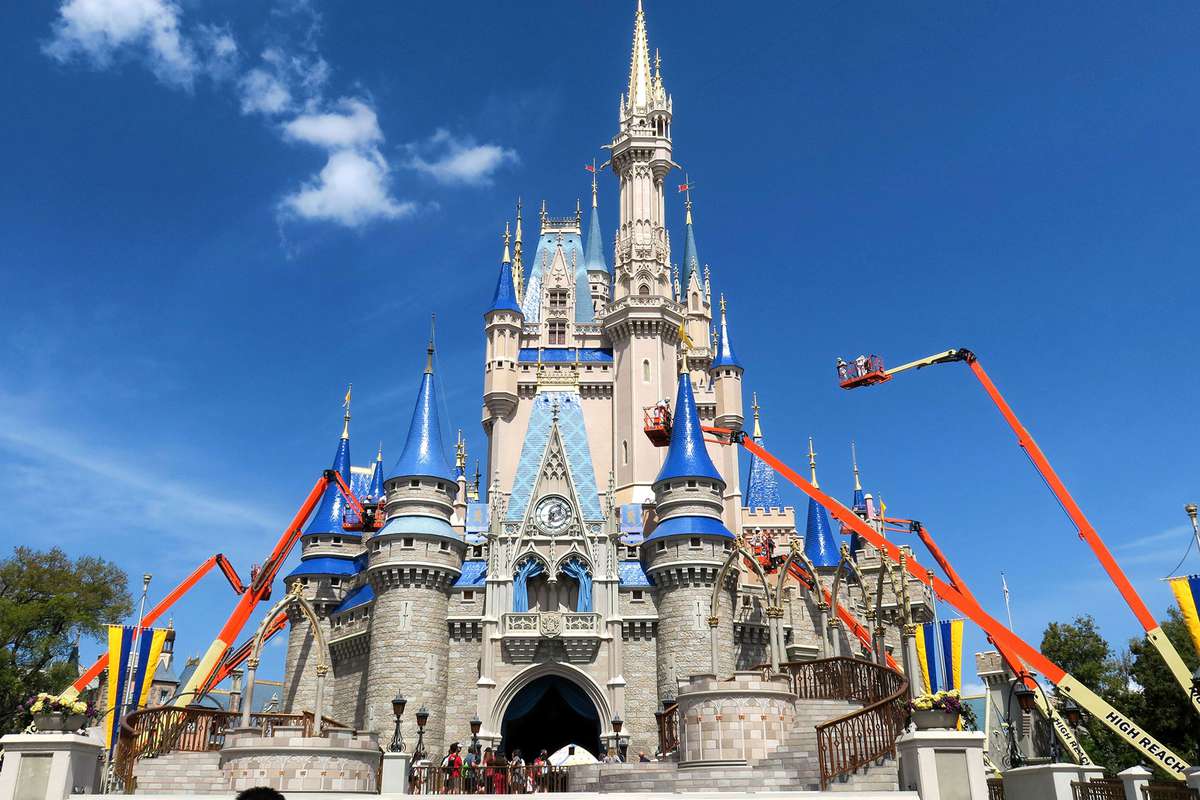 workers paint Cinderella Castle at Disney World