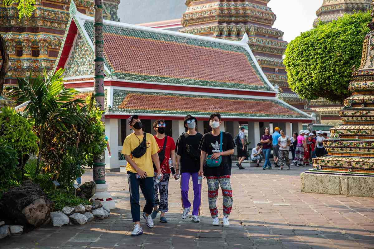 tourists wear masks at Wat Pho, Thailand