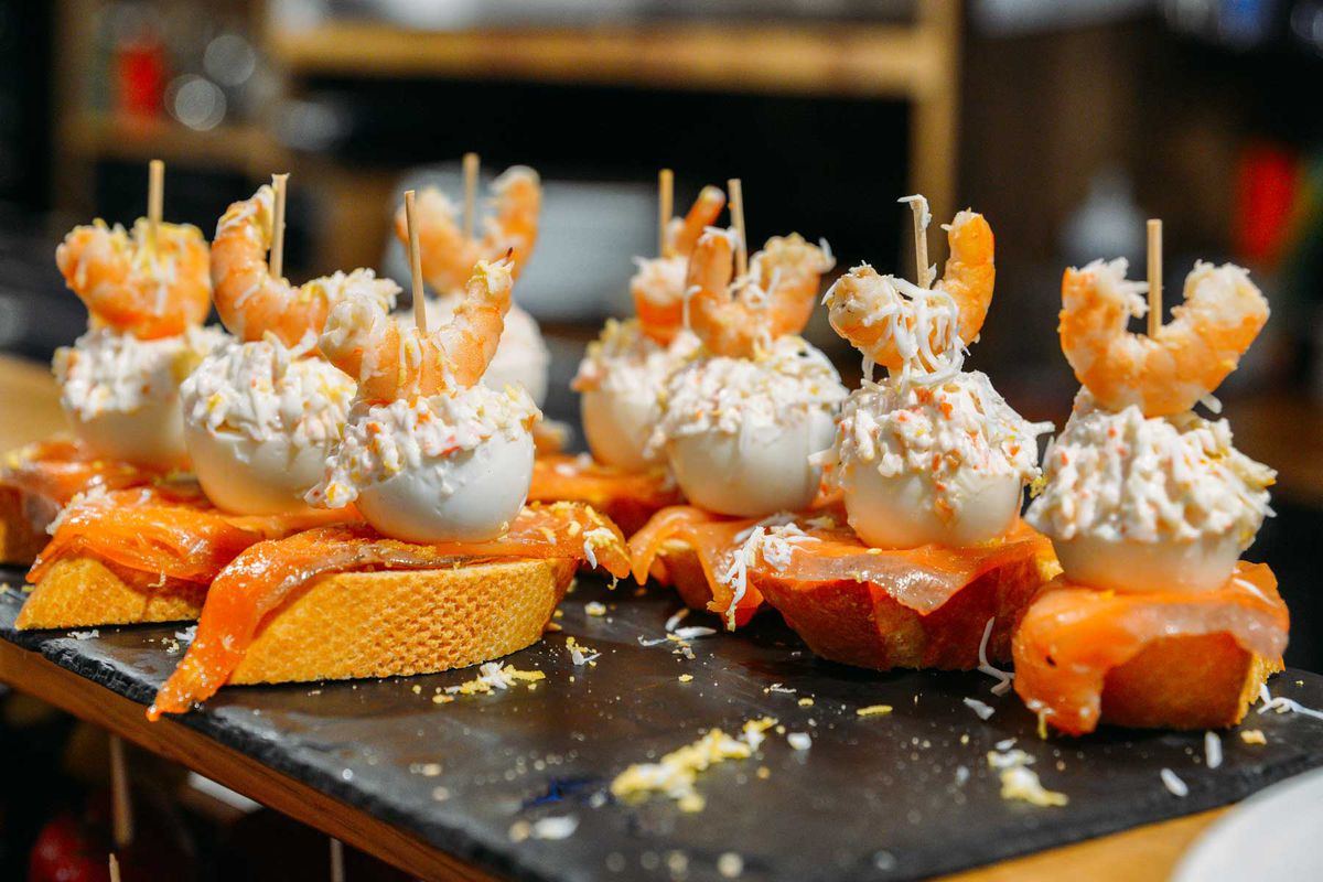 Spanish tapas called pintxos of the Basque country served on a bar counter in a restaurant in San Sebastian, Spain