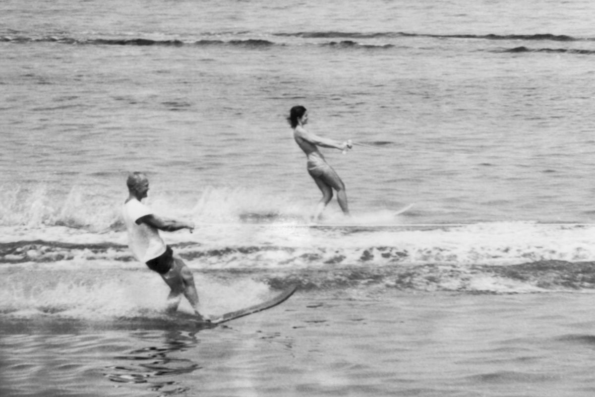 Jackie Kennedy and astronaut John Glenn water skiing at the Kennedy compound. a