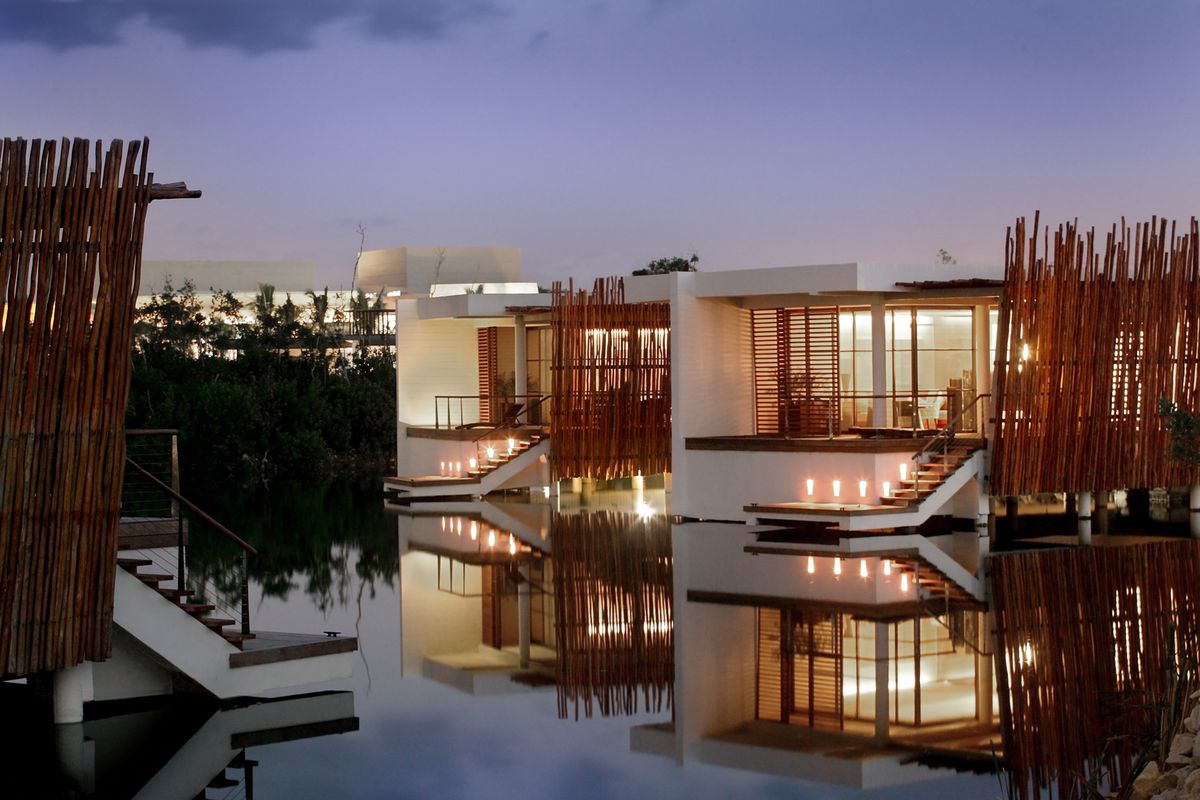 Lagoon suites at night at Rosewood Mayakoba, a luxury resort in Mexico.