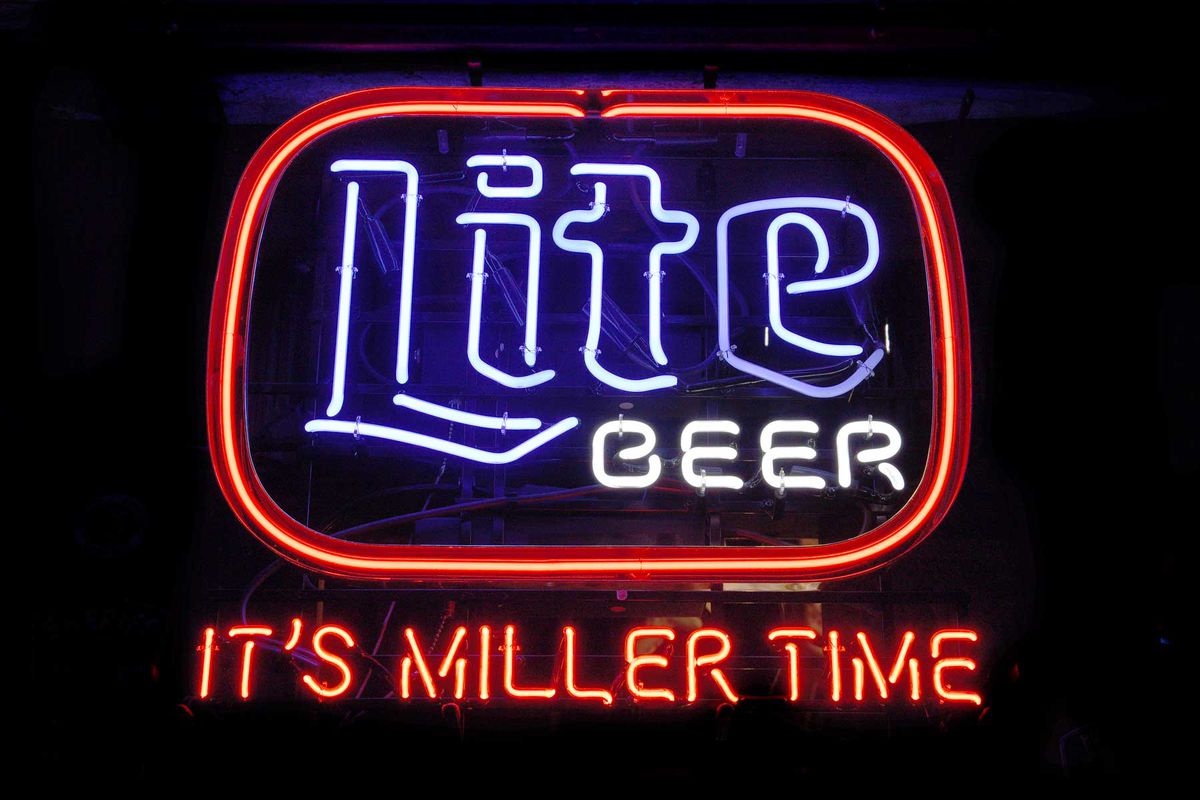 A neon sign advertising Miller Lite beer burns in the general store and bar at Luckenbach, Texas, an unincorporated community near Fredericksburg, Texas