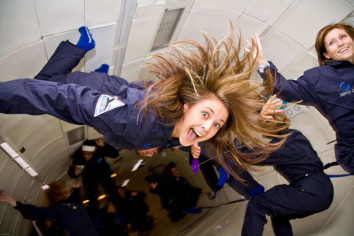 people floating in a zero gravity plane cabin