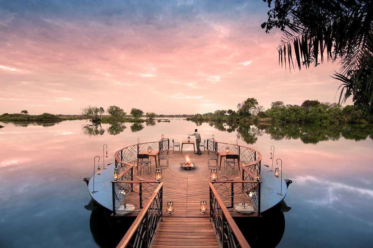 A floating dock with candle light at sunset in Zambia