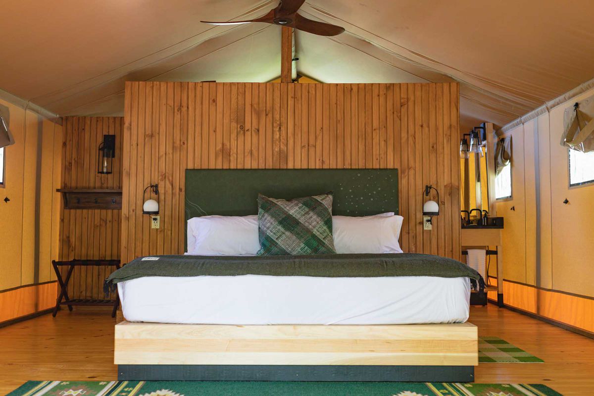 Bed inside luxury glamping tent