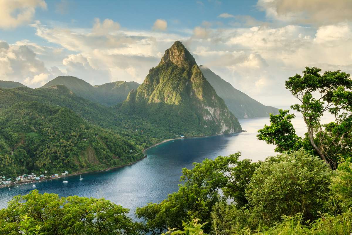 View of St Lucia's Petit Piton & Gros Piton from an elevated viewpoint with the rainforest and bay of Soufrière in the foreground