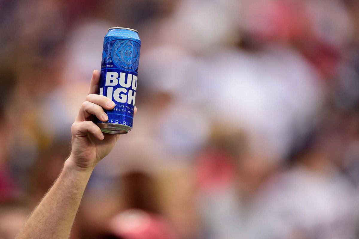 A fan holds up a can of Bud Light during a football game