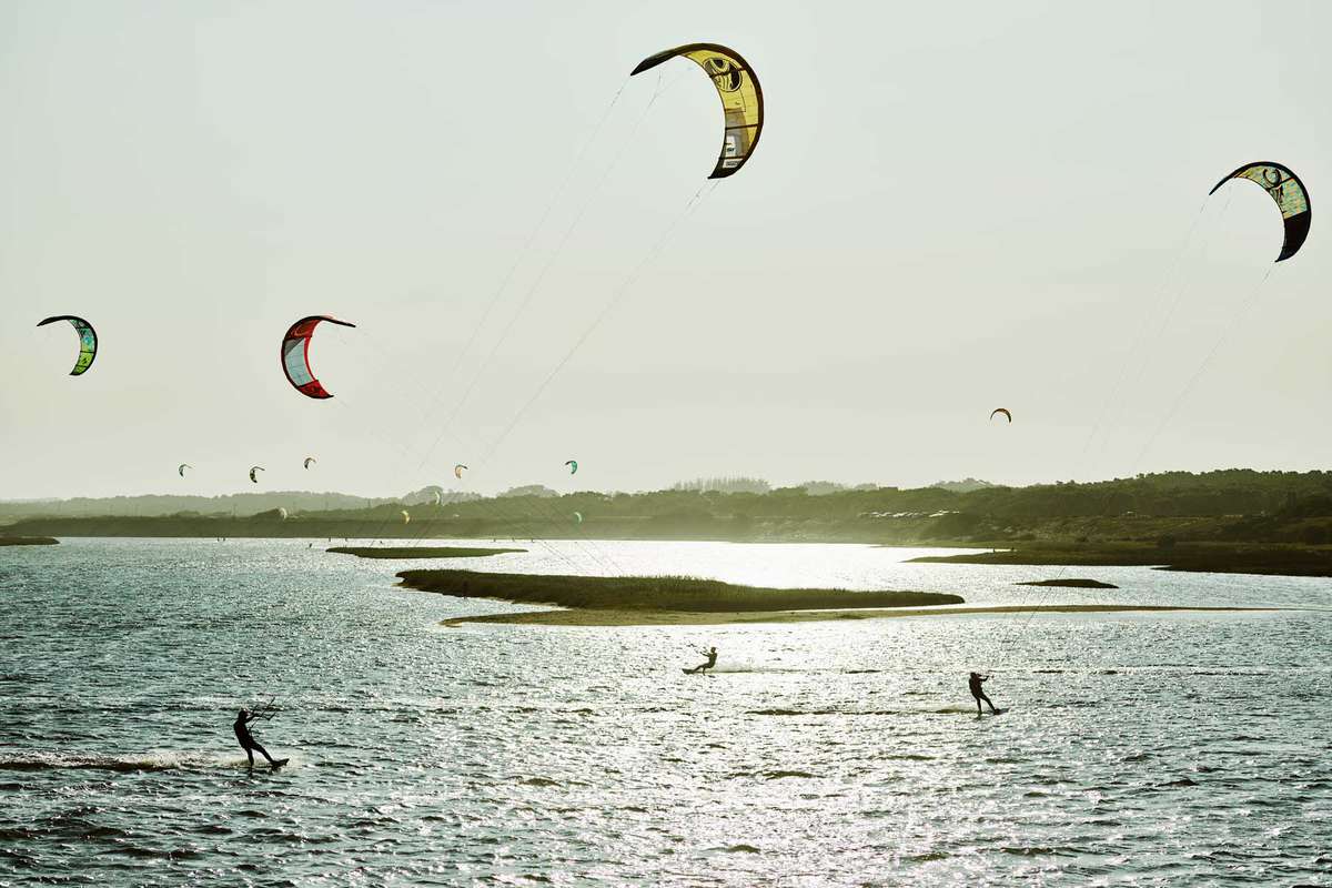 Kitesurfers at Laguna Garzón in Uruguay at golden hour
