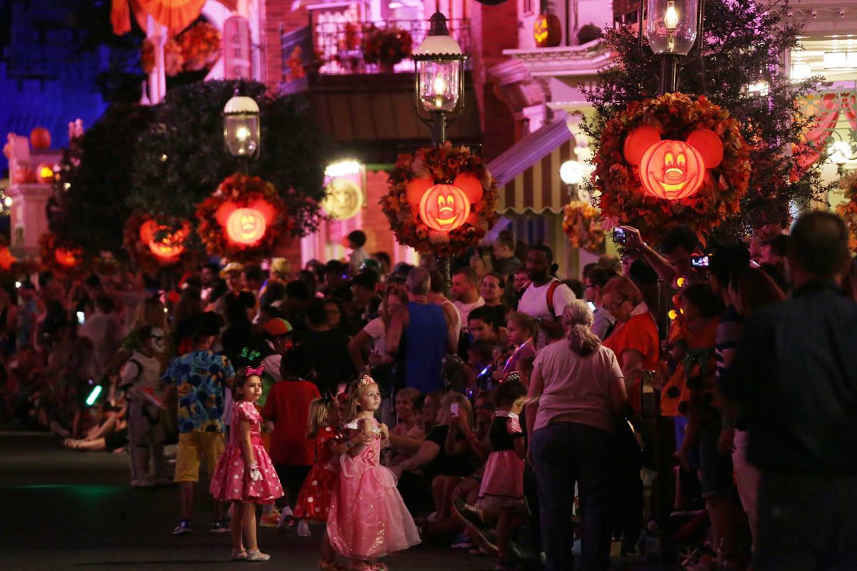 Guests wait along Main Street USA for Mickey's "Boo-To-You" Halloween Parade at Walt Disney World Magic Kingdom on Friday, Sept. 18, 2015.