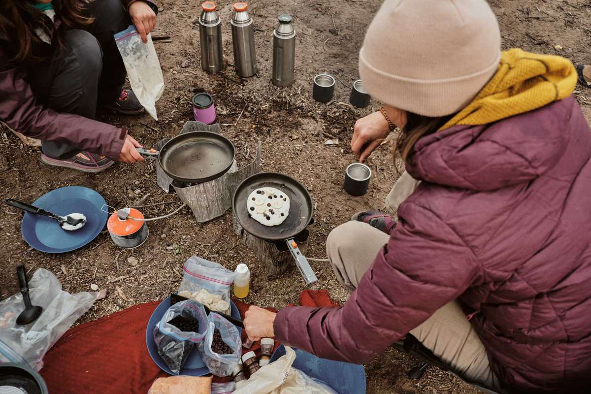 People cooking at a campsite