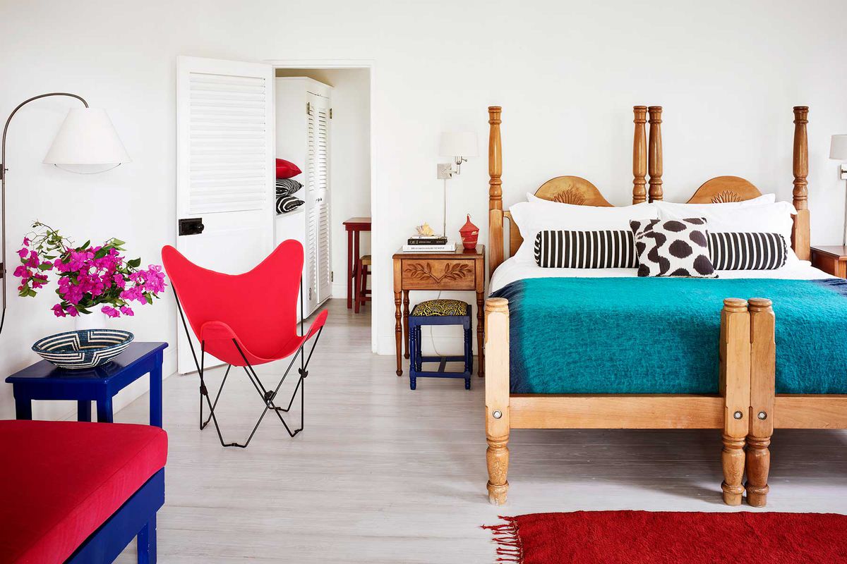 A bright hotel room with fun colored furnishings