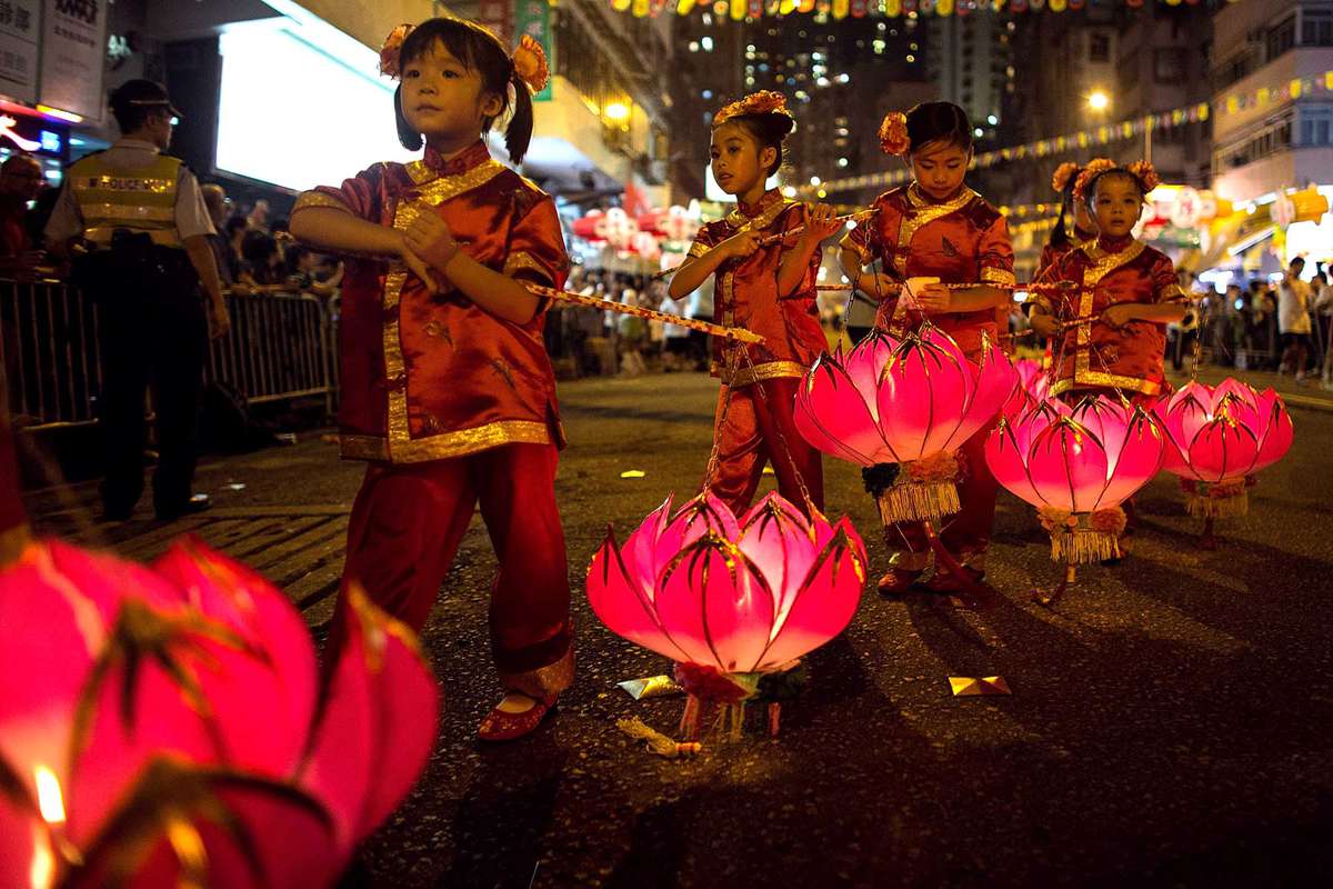 Residents of Tai Hang perform the Fire Dragon Dance to celebrate the Mid-Autumn Festival in Tai Hang area on September 8, 2014 in Hong Kong, China.