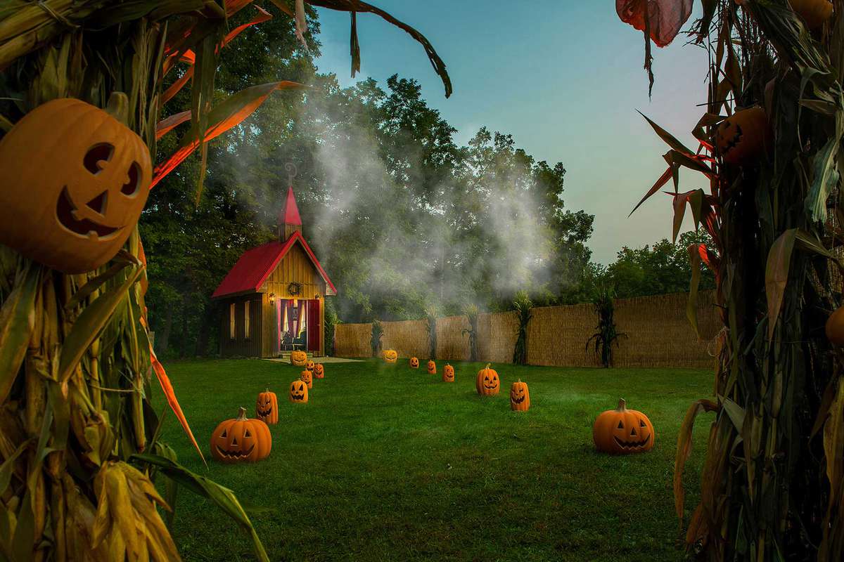 Airbnb entrance with jack-o-lanterns and corn stalks