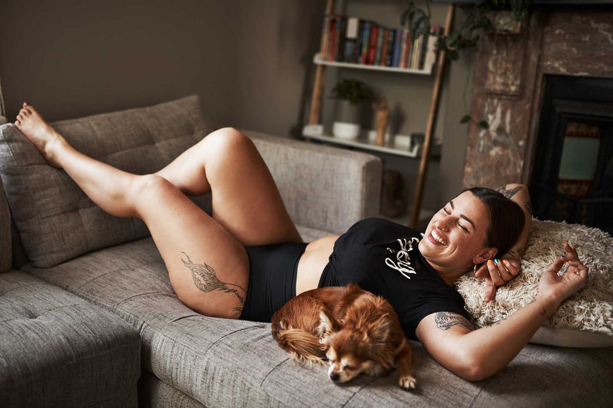 Woman lounging at home with her dog in underwear