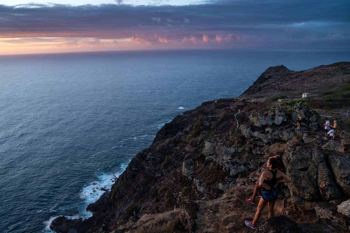 Luz Gutierrez, 54, and her daughter, Jane Gutierrez, 30, both of Hawaii Kai, watch the sunrise from the Makapuu Point Lighthouse Trail on the eastern shore of the island of Oahu on Monday, Oct. 19, 2020