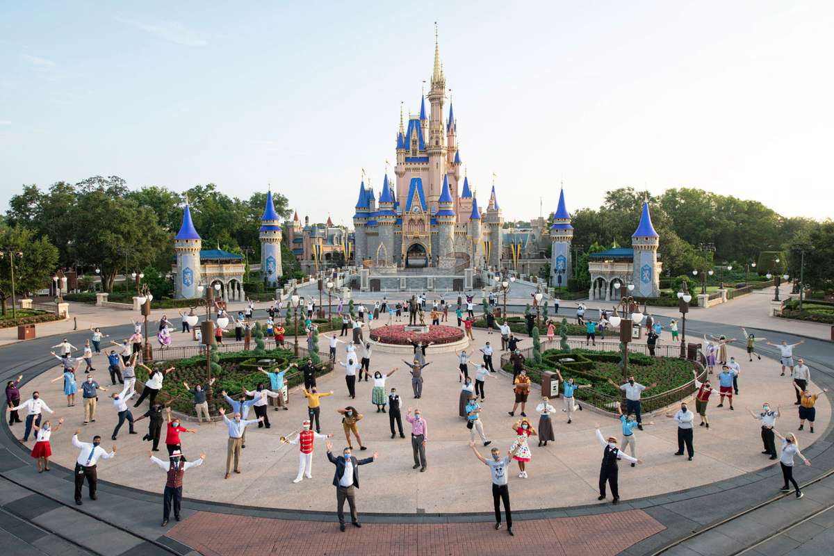 Disney cast members in front of Disney World's Magic Kingdom