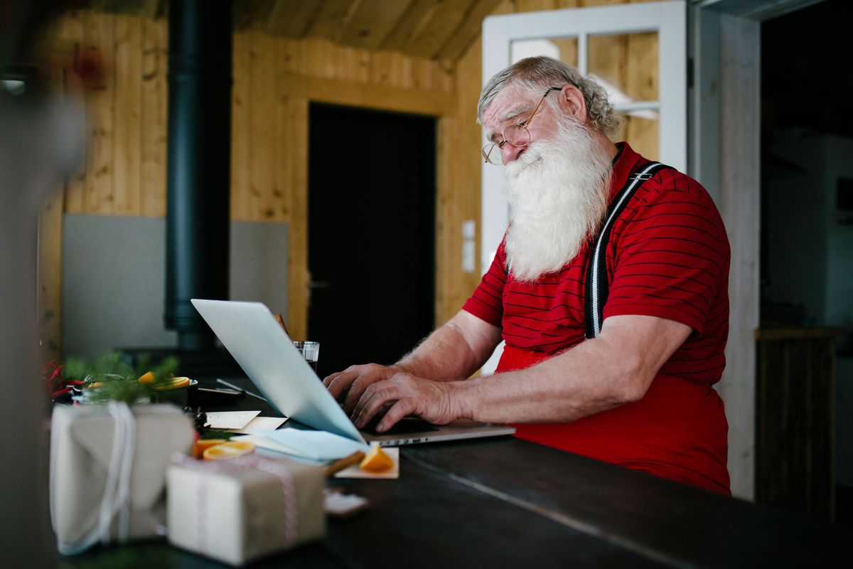 Santa Claus using a laptop computer