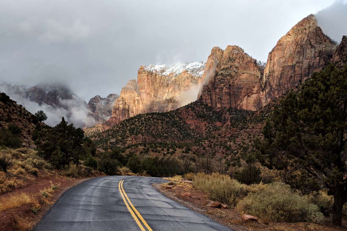 Snow on peaks and clearing clouds on scenic road in Zion National Park in Utah