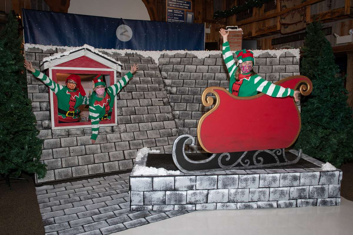 Elves in Santa's sleigh on a rooftop set at Columbus Zoo
