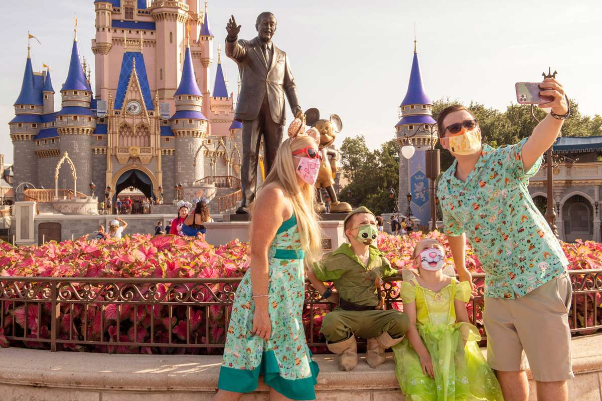 guests stop to take a selfie at Magic Kingdom Park