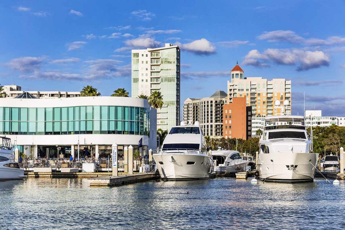 Marina Jack restaurant and yachts with city skyline in Sarasota, Florida