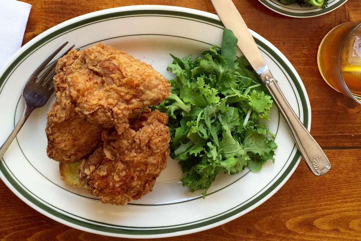 Plate of Hot Fried Chicken and greens from Peaches HotHouse in Brooklyn