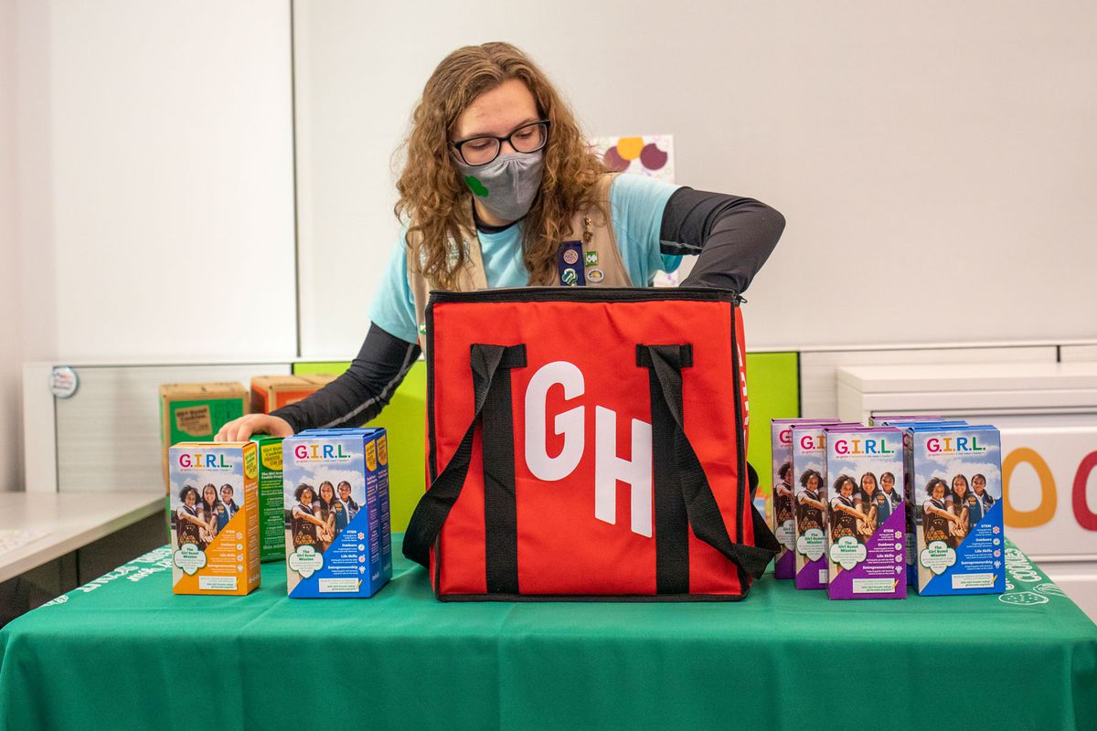 Woman packaging Girl Scout cookies on Grubhub