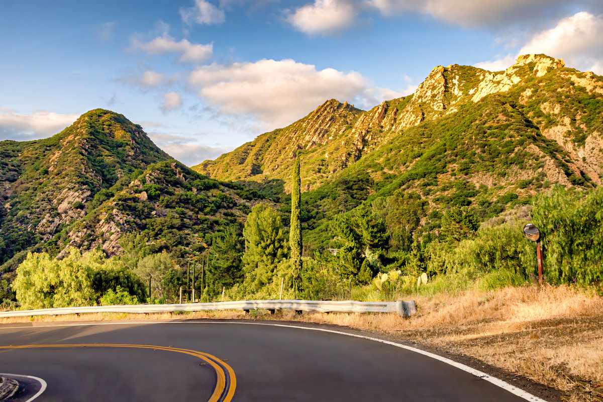 Driver's view of the beautiful Santa Monica mountains in southern California, seen from winding road.