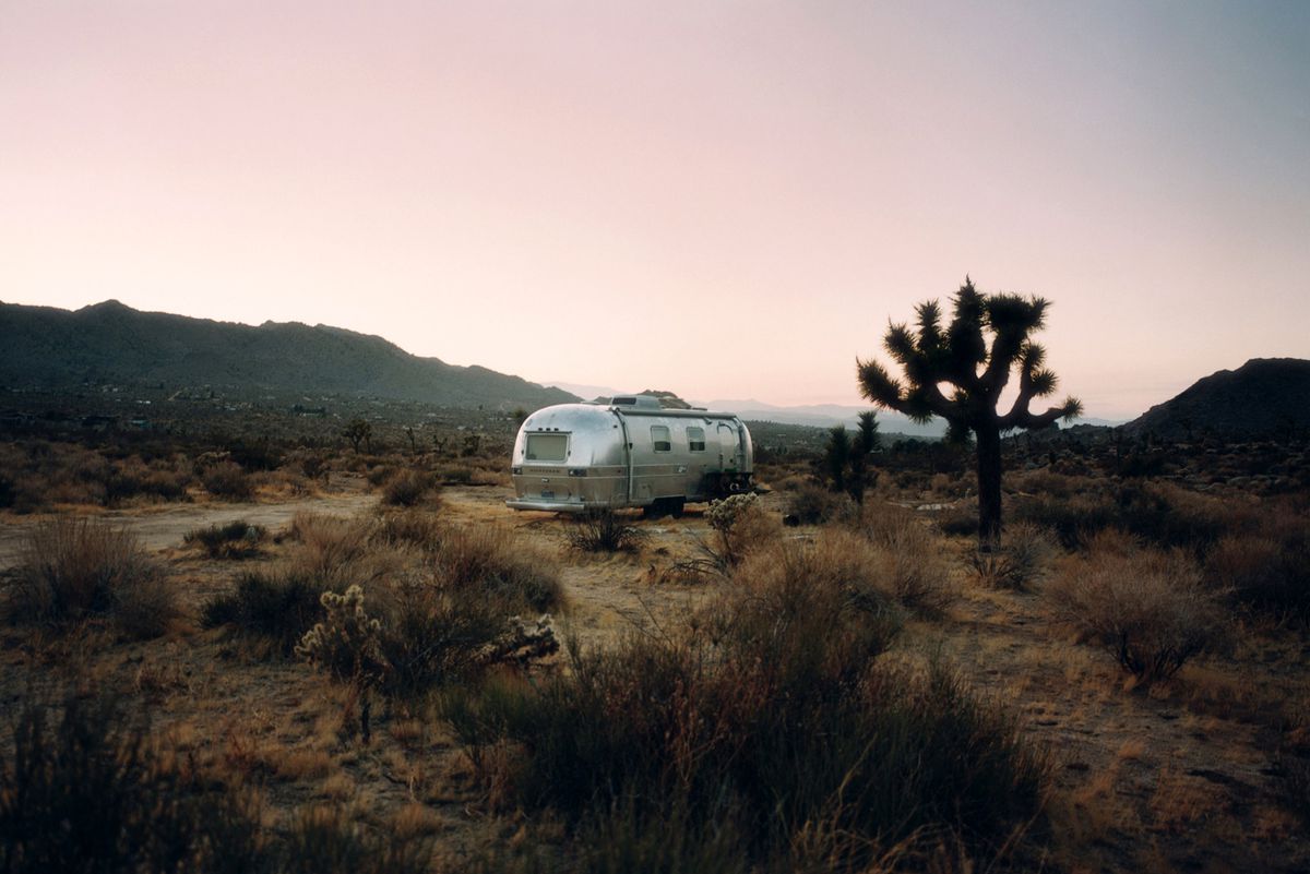 Silver Airstream trailer parked in desert