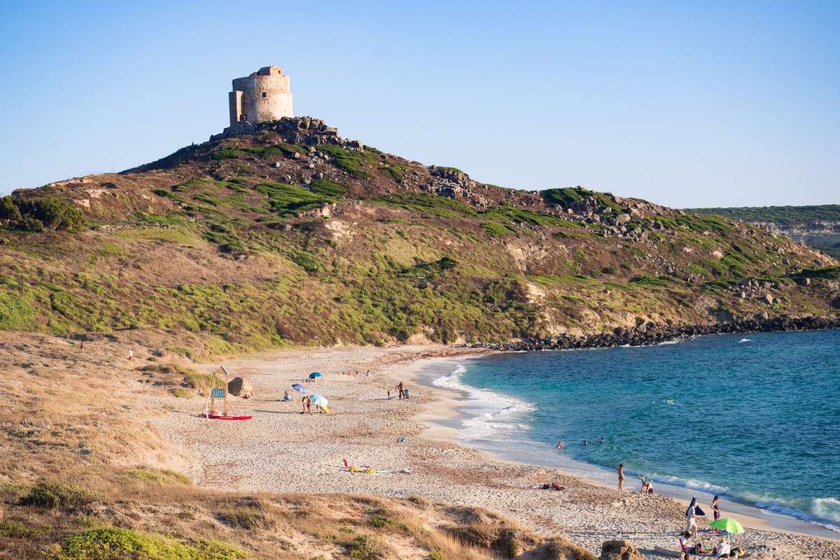 Sunset beach of San Giovanni di Sinis (Sardinia, Italy) and in the background the old tower.