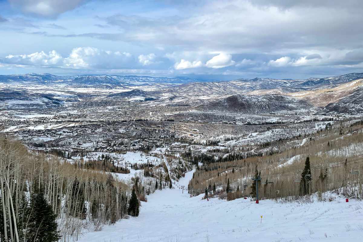 View of Rocky Mountains and a ski run on Snowmass ski resort.