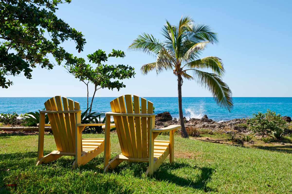 Lounge chairs facing the sea on the grounds of Jakes resort, in Jamaica