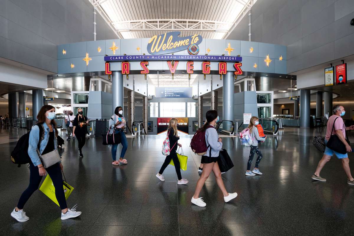 passengers walk through McCarran International Airport
