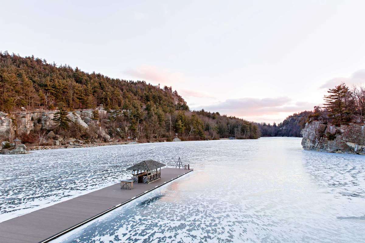 The dock at Mohonk Mountain House in winter, extending out onto frozen Lake Mohonk