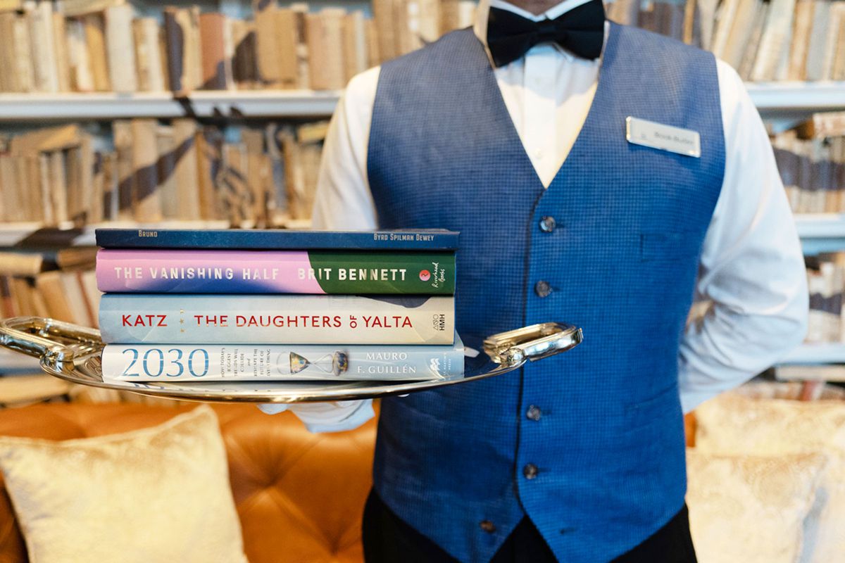 a 'Book Butler' holding a try of books