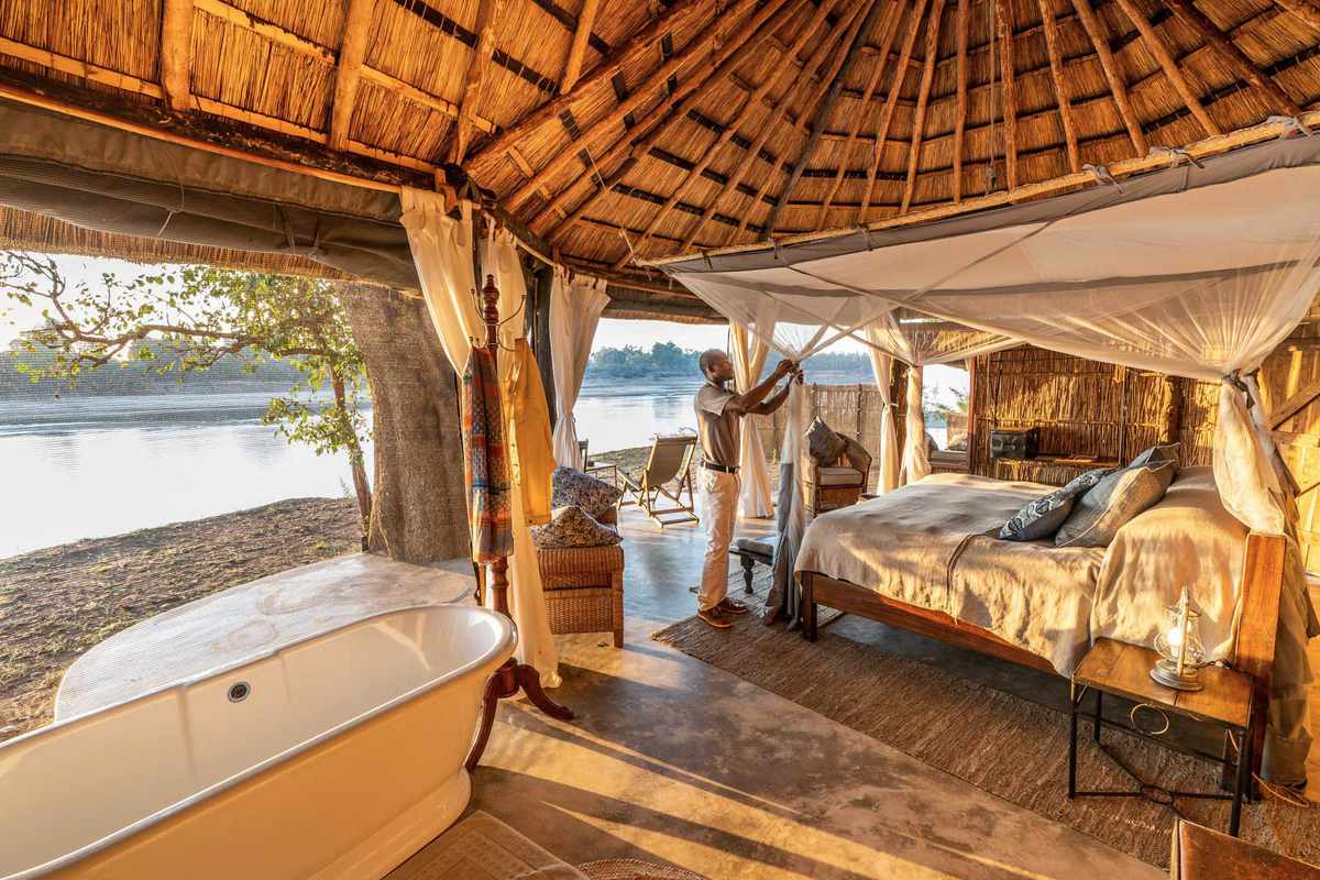 A staff member readies a guest room at the Time + Tide Mchenja property on the banks of the Luangwa River in Zambia