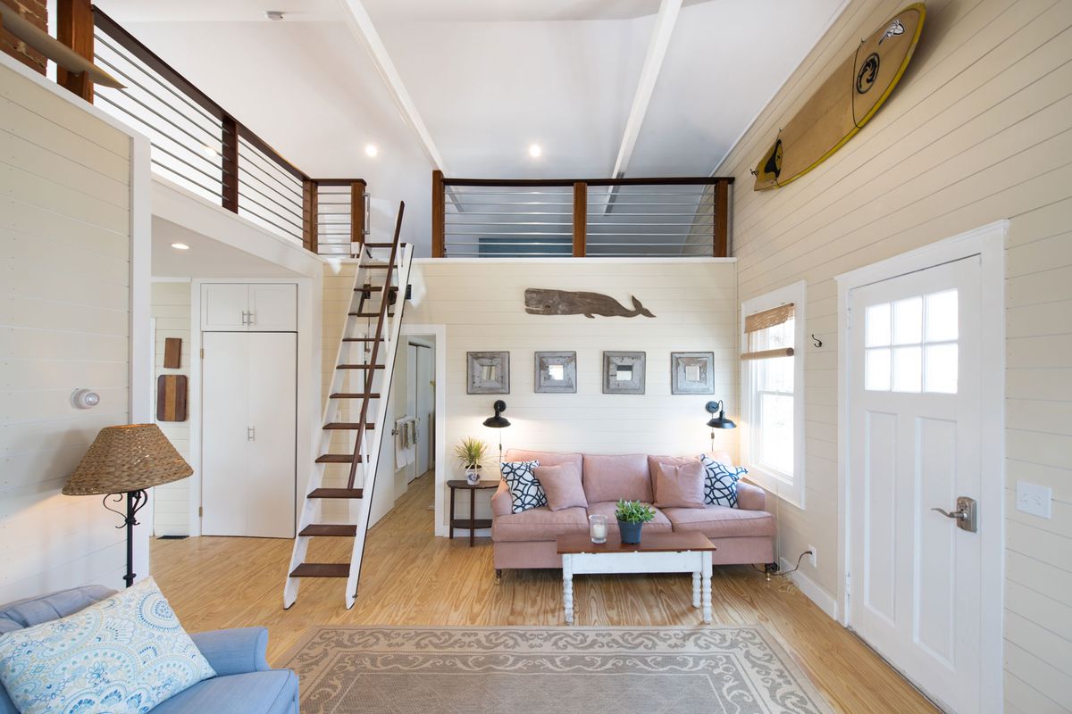 Interior of beach house with loft and pink couch