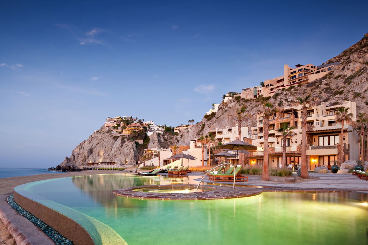 Waldorf Astoria Cabo swimming pool by ocean with hotel built into cliff