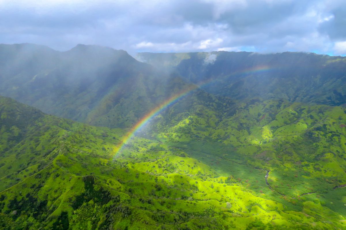 Rainbow in an aerial view of Na Pali Coast, Kauai, Hawaii