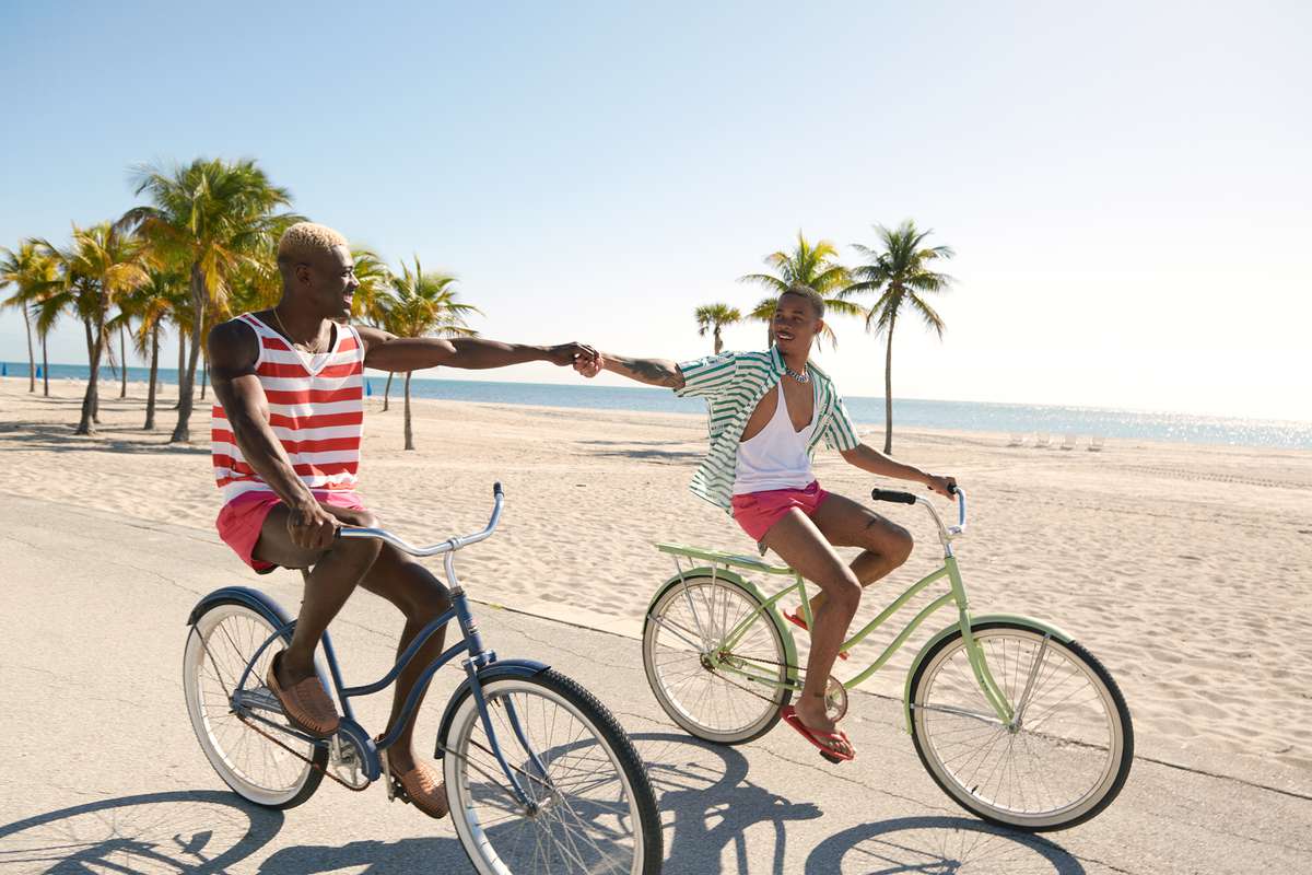 couple riding bikes by the beach
