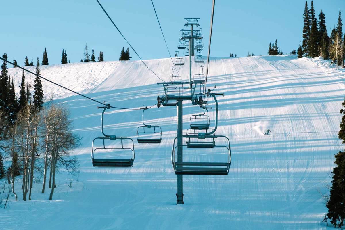 Ski lift with a skier at mountain resort in Utah