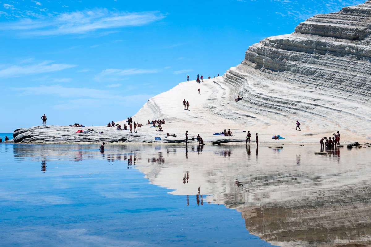 Sun-bakers at Scala dei Turchi, or Stairs of the Turks, at Realmonte, southern Sicily, Italy.