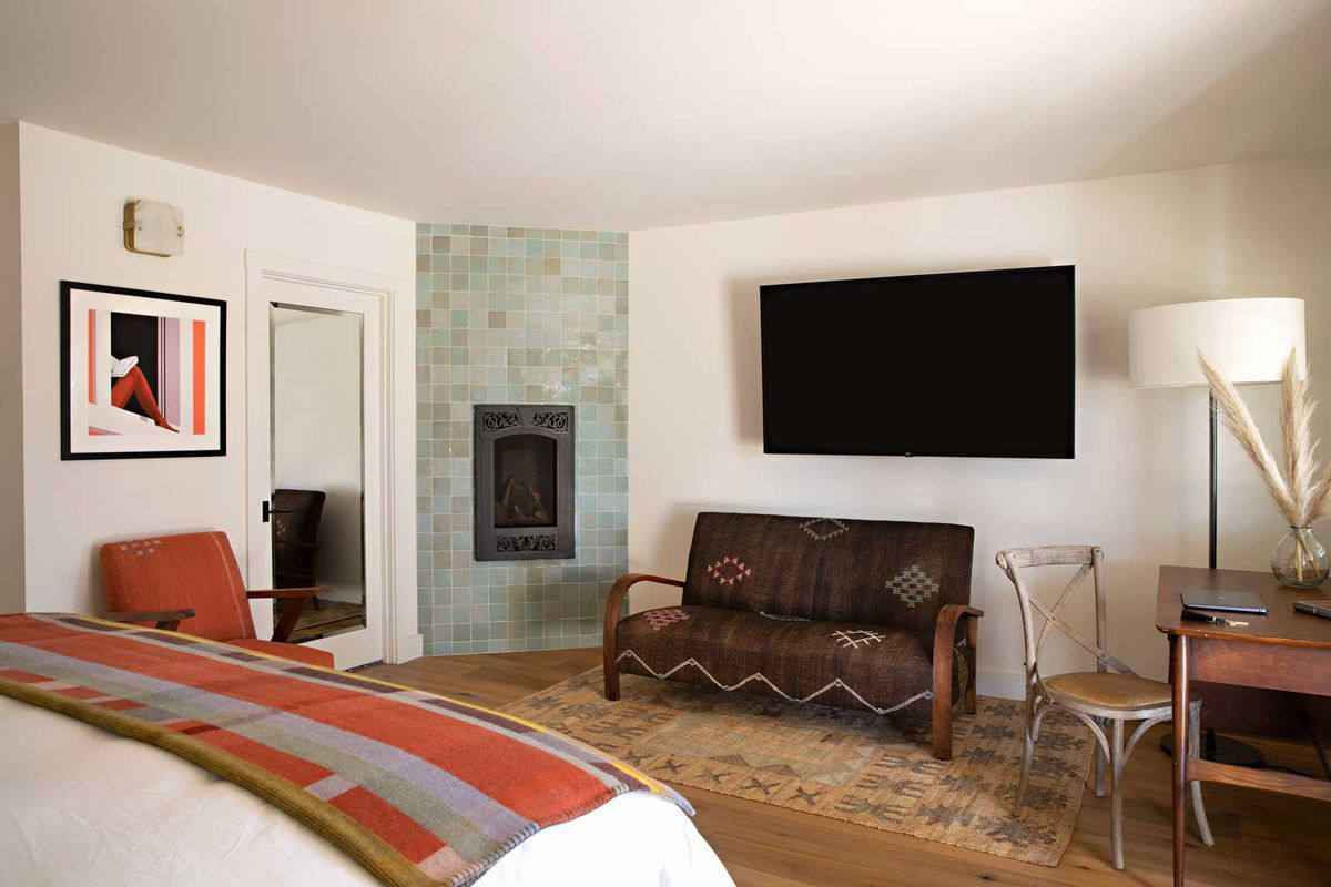 Deluxe bedroom with fireplace at Hotel Ynez