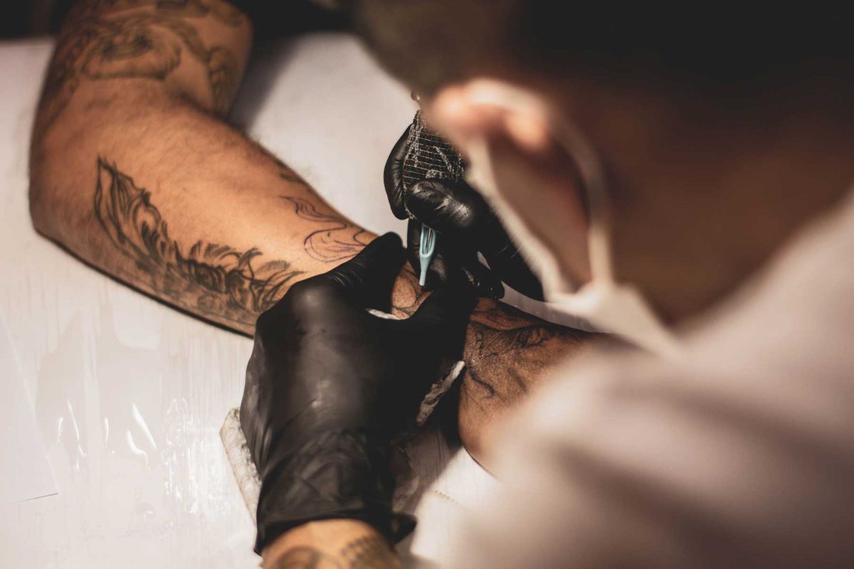 Tattoo artist giving tattoo