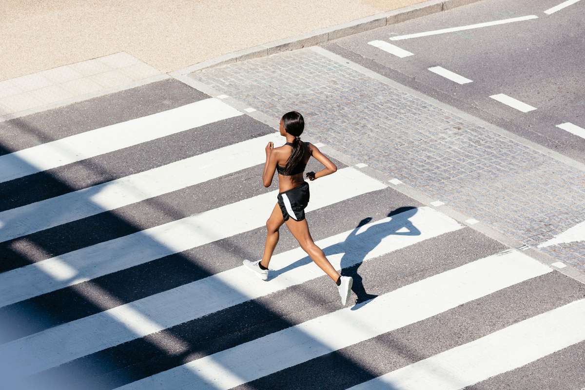 Woman running in crosswalk