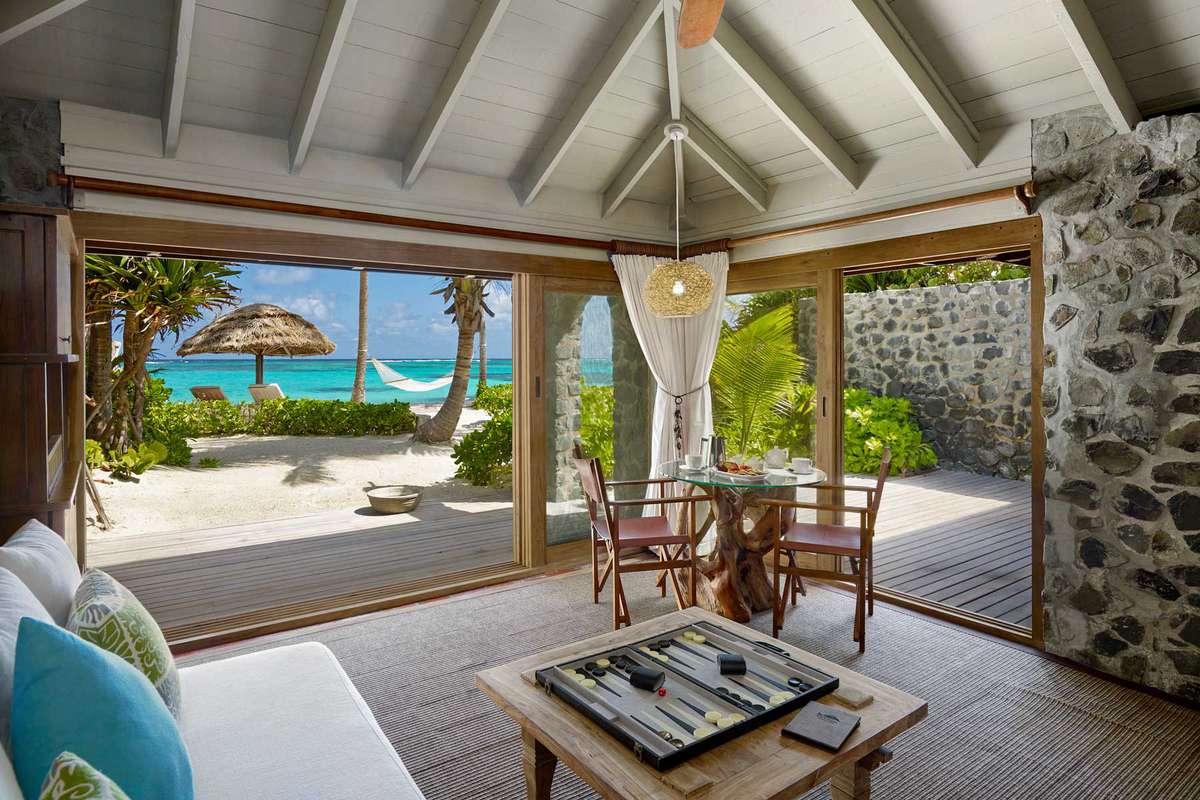 View from inside a stone-walled cottage looking out to sea views, in the Caribbean