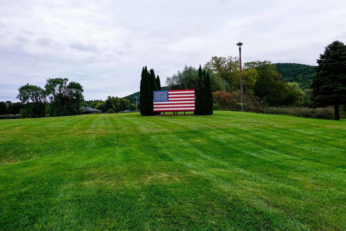 Pine Plains, New York, USA An American flag on the side of the road.