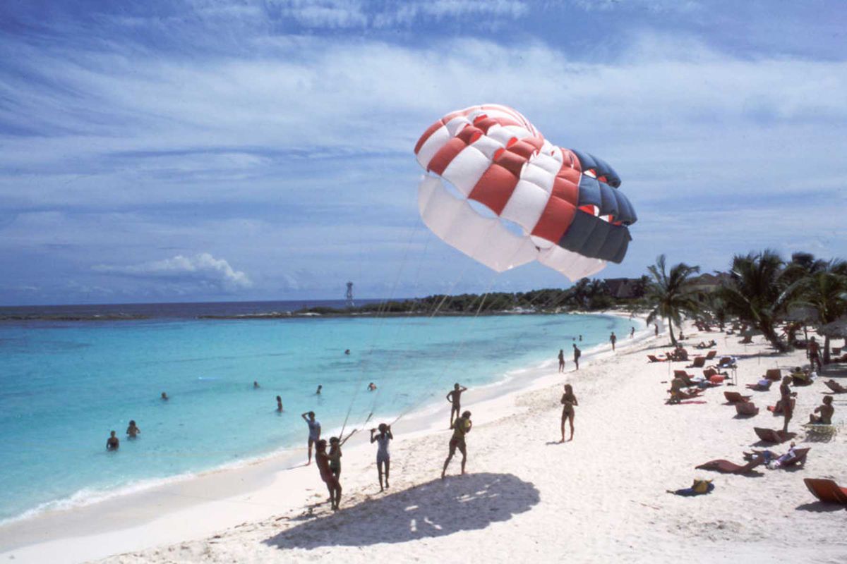 Parachute play on the beach of Club Med in October 1982 in Cancun, Mexico