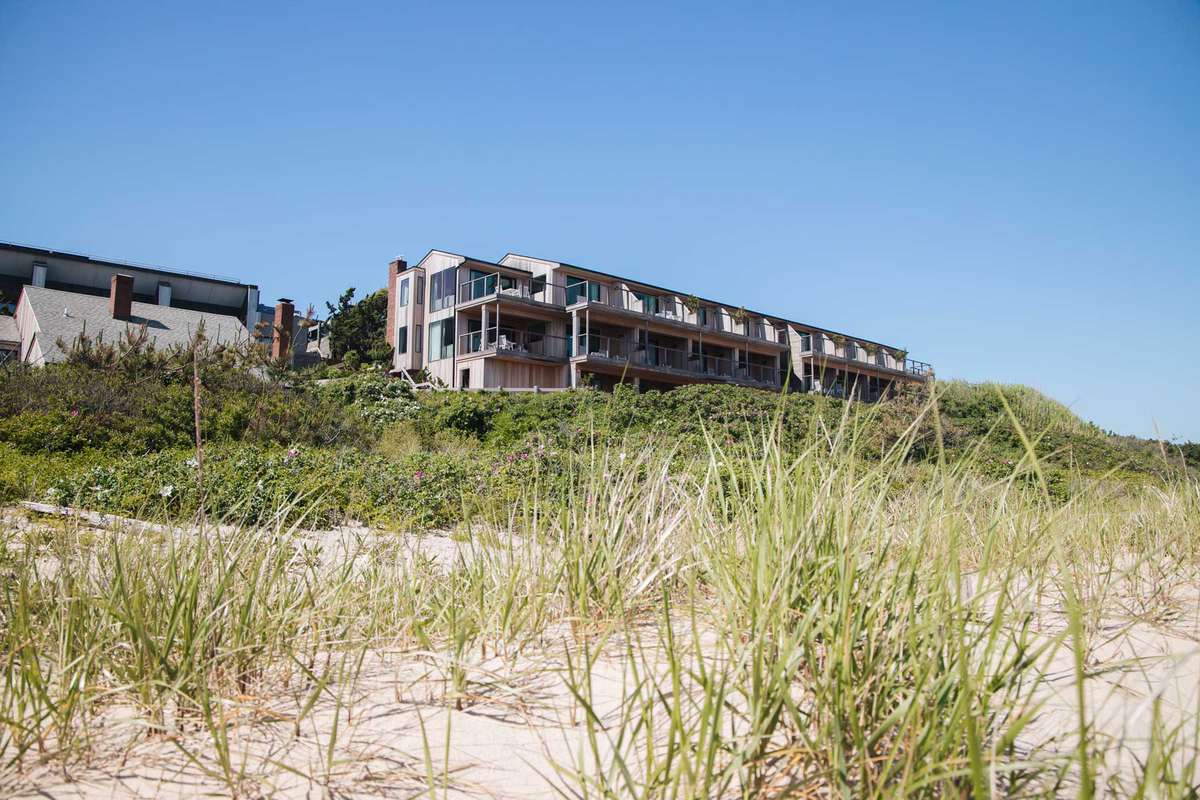 Exterior view of Gurney’s Montauk from the grassy hills of the beach
